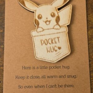 Engraved basswood long-eared creature pocket hug displayed on a small keepsake message card