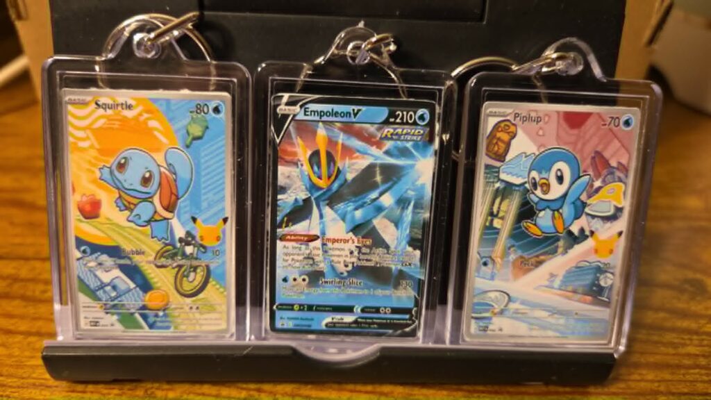 Three personalized Pokémon-style trading card keychains