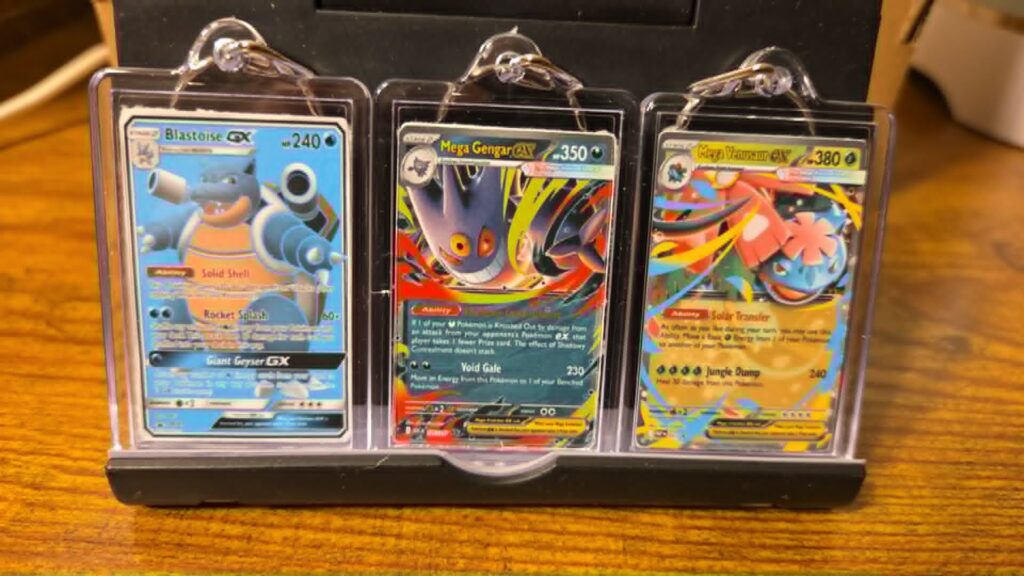 Three personalized Pokémon-style trading card keychains